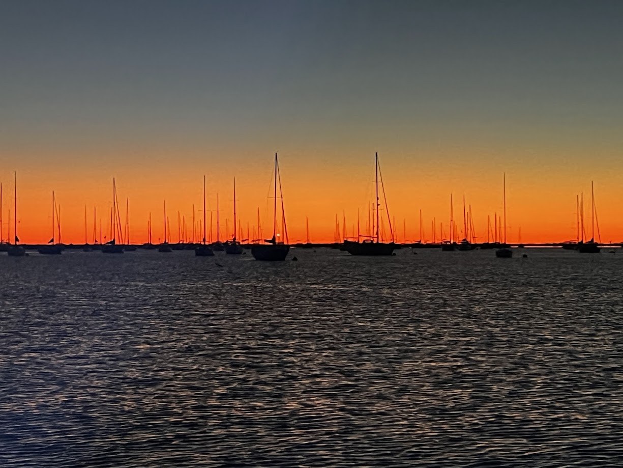Sailboats silhouetted against a Hudson River sunset